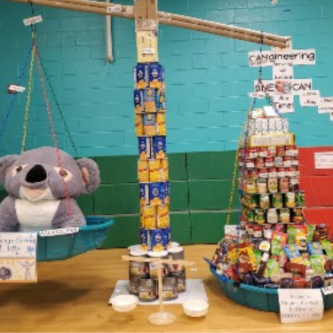 Keene CANgineering Award display of Cans with boxes of food, cand goods, and more!